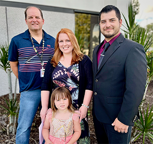 Tax Collector Ken Burton Jr., with Employee of the Third Quarter 2022, Anna Barr Sosa, and Anna's husband and daughter